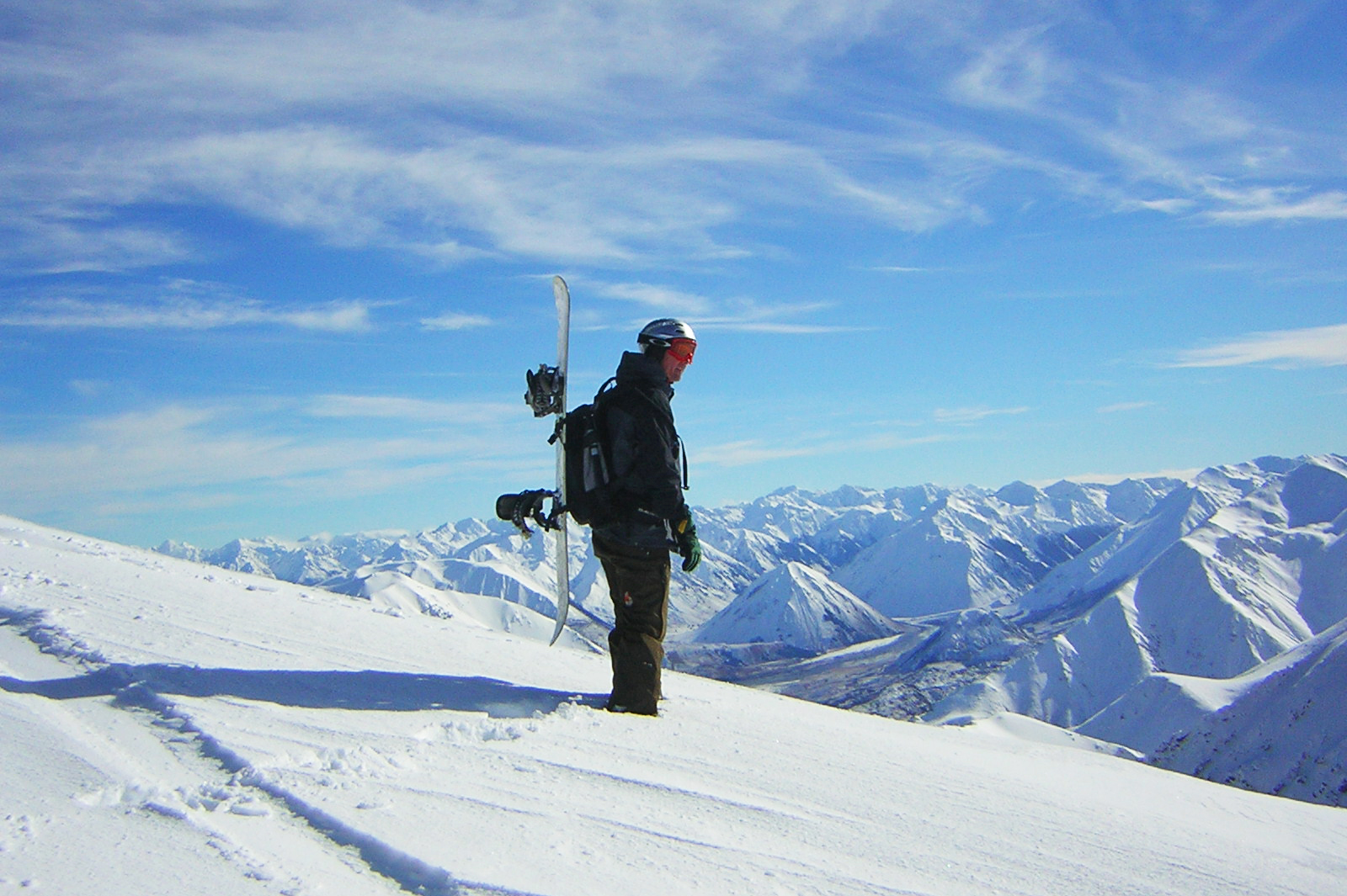 Man on snow mountain looking backwards. 