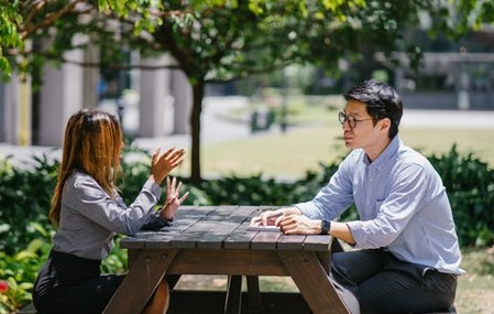 Two people in conversation outside